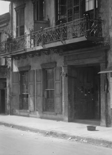 Facades of buildings along a street in the French Quarter, New Orleans, between 1920 and 1926. Creator: Arnold Genthe.