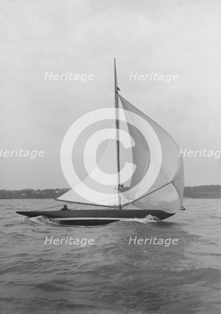 The 7 Metre yacht 'Pinaster' (K8) sailing with spinnaker, 1913. Creator: Kirk & Sons of Cowes.