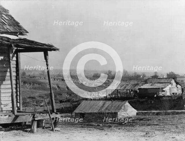 New outskirts of town, showing Negro houses and soil erosion, Tupelo, Mississippi, 1936. Creator: Walker Evans.