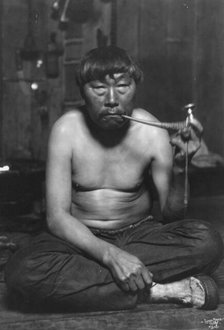 Eskimo smoking pipe, between c1900 and 1927. Creator: Lomen Brothers.