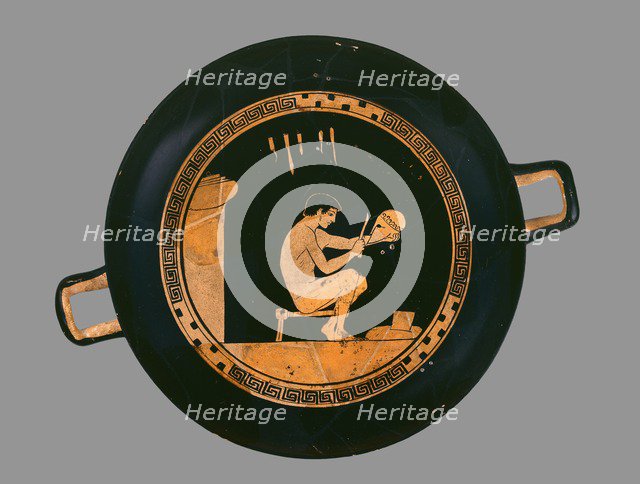 Attic red-figure cup depiting a seated helmet maker and his equipment, c480 BC. Artist: Antiphon Painter.