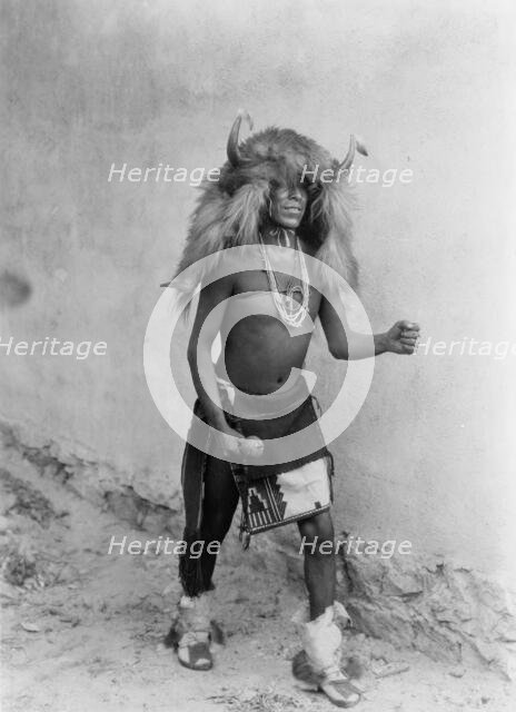 Sia buffalo dancer. Full-length, standing, facing right, c1926. Creator: Edward Sheriff Curtis.