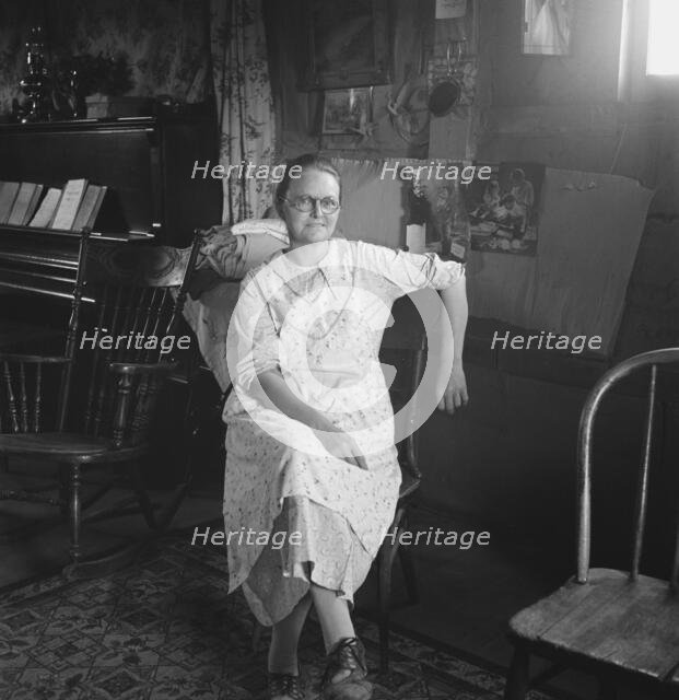 Mrs. Hull in one-room dugout basement home, Dead Ox Flat, Malheur County, Oregon, 1939. Creator: Dorothea Lange.