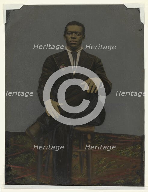 Tintype of a man wearing a suit with a pendant on the lapel, early 20th century. Creator: Unknown.