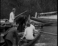 Young Female Civilians Wearing Sport Outfits Climbing Into a Rowing Boat, 1920. Creator: British Pathe Ltd.
