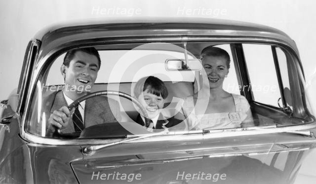 1957 Vauxhall Victor with family together in front seat. Creator: Unknown.
