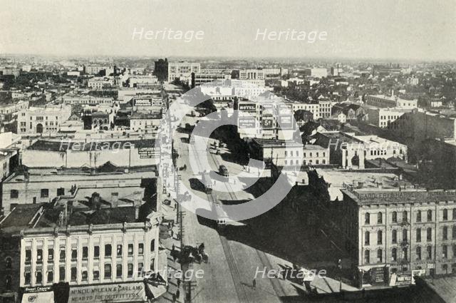 'Winnipeg To-Day; Looking Up Main Street. - The Rapid Growth of Modern Canada', c1930. Creator: Valentine & Sons Ltd.