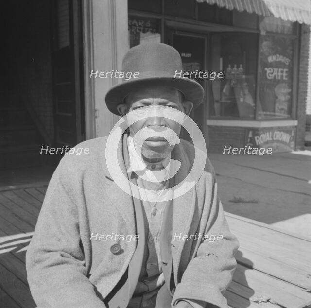 Men sitting in the sun on Sunday morning, Daytona Beach, Florida, 1943. Creator: Gordon Parks.