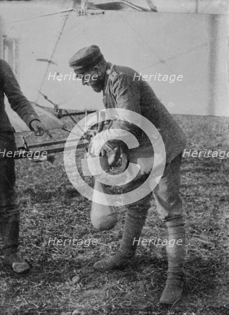 Attaching bomb to German Aeroplane, 16 Jan 1915. Creator: Bain News Service.