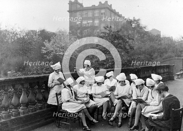Girls read in an outdoor class, Rowntree factory, York, Yorkshire, 1933. Artist: Unknown