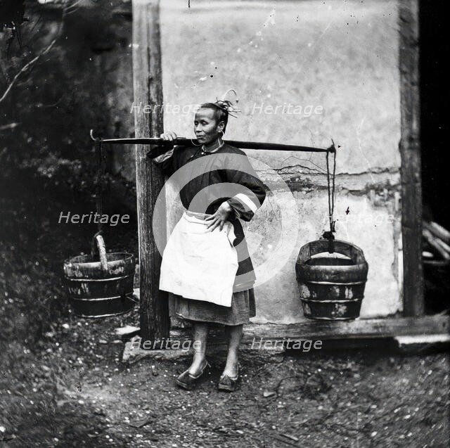 Foochow, Fukien province, China: a woman carrying buckets of night-soil, 1869 (1981). Creator: John Thomson.