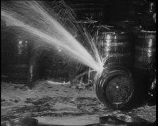 Barrels of Alcohol in a Cellar Being Destroyed During Prohibition, 1930. Creator: British Pathe Ltd.