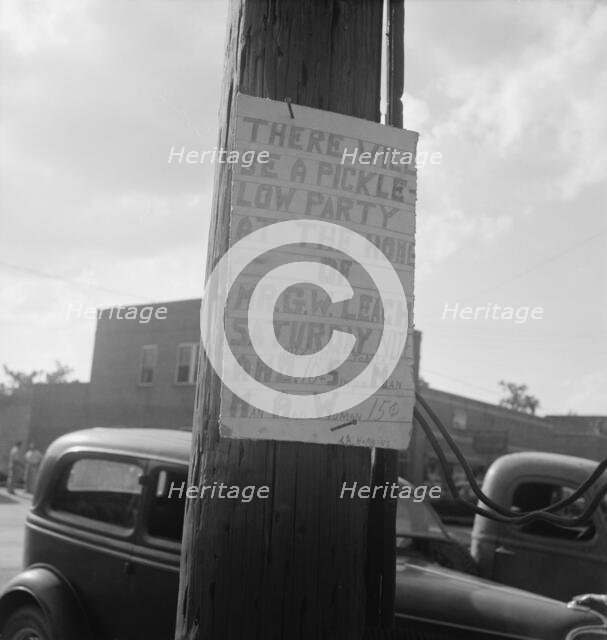 Sign tacked to pole near the post office, Main street, Pittsboro, North Carolina, 1939. Creator: Dorothea Lange.