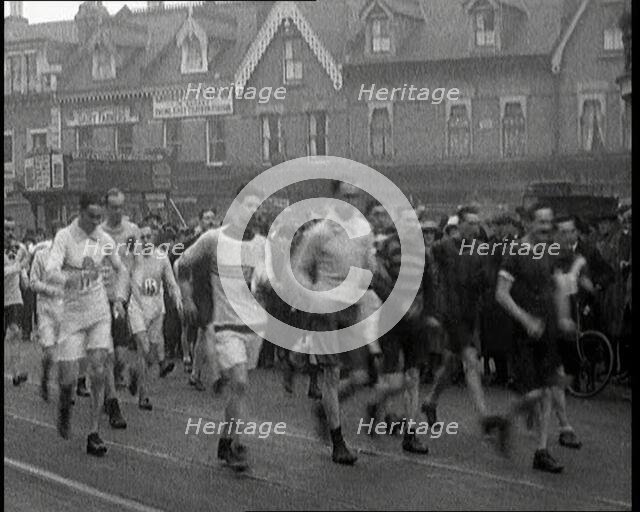 Crowds Watching a Men's Walking Race in the Street, 1920. Creator: British Pathe Ltd.