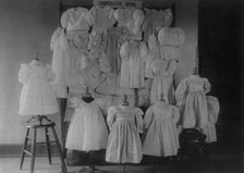 Dresses, possibly made by students in a Washington, D.C. school, on display, (1899?). Creator: Frances Benjamin Johnston.