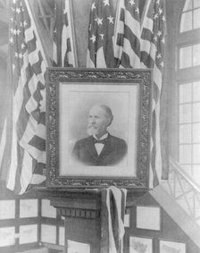 James Wilson, 1857-1932; photo of flag-decked framed bust portr. facing left, n.d.. Creator: Frances Benjamin Johnston.