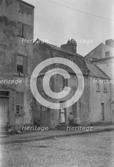 Woman and child standing in or by a doorway, [17 Chalmers Street], Charleston, South Ca., c1920-1926 Creator: Arnold Genthe.