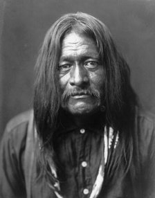 Hoo-Man-Hai, Maricopa Indian, head-and-shoulders portrait, facing front, c1907. Creator: Edward Sheriff Curtis.