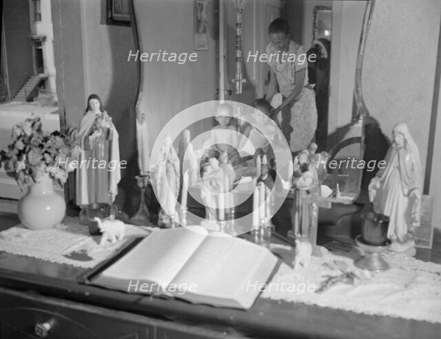 Religious objects and an improved altar in the bedroom..., Washington, D.C., 1942. Creator: Gordon Parks.