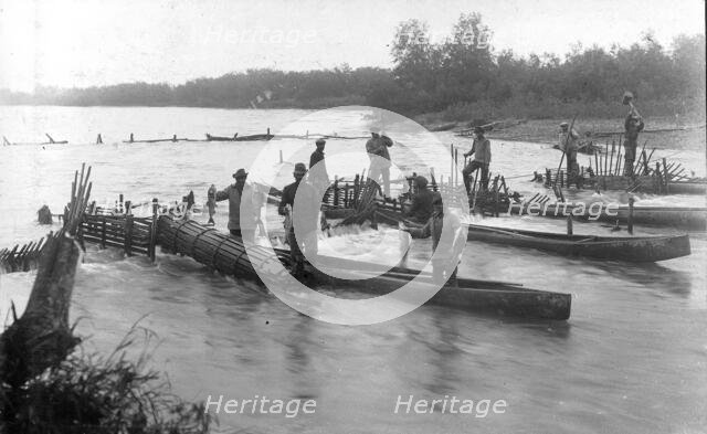 Kamchadals on baht pull out fish from the “muzzles” of the “constipation”..., 1910-29. Creator: Ivan Emelianovich Larin.
