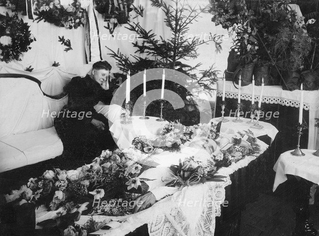 A widow grieving for her husband at a wake, Sweden. Artist: Unknown