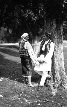 Couple in traditional costume, Bistrita Valley, Moldavia, north-east Romania, c1920-c1945.  Artist: Adolph Chevalier