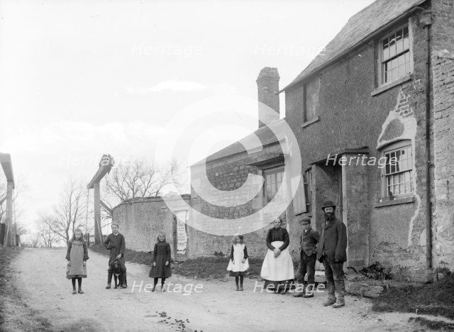 Family outside their cottage with the canal bridge in the background, Uffington, Oxfordshire, 1916. Artist: Henry Taunt
