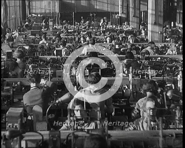 Female Civilians Working on a Factory Production Line, 1931. Creator: British Pathe Ltd.