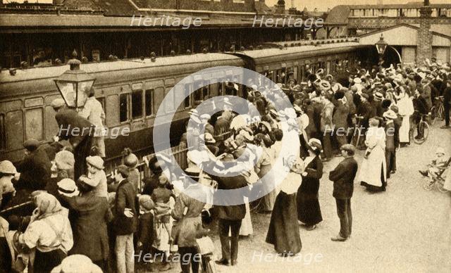 Crowds waving off troops leaving to fight in the First World, War, Britain, 1914, (1933). Creator: Unknown.