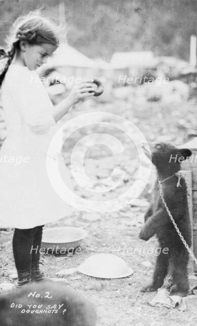 Girl and bear cub, between c1900 and 1916. Creator: Unknown.