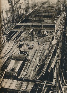 'More than 1,000 Feet Long. Shell of Queen Mary in early days of construction',  1930-1934, (1936). Artist: Unknown.