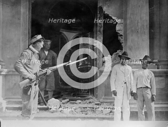 Vera Cruz: Front door of Naval Academy bombarded by "CHESTER" & "PRAIRIE", 1914. Creator: Bain News Service.