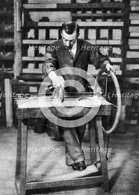 Wire being wound into springs for spring-locks, London, 1926-1927. Artist: Unknown