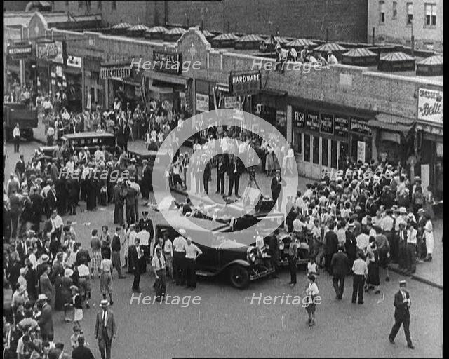 Crowded New York City Street Where Police and Ambulance Attend to Dead and Dying Victims..., 1932. Creator: British Pathe Ltd.