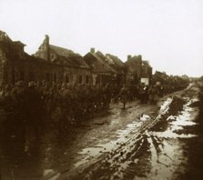 Soldiers marching past bombed-out houses, Champagne, northern France, c1914-c1918. Artist: Unknown.