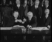 Frank Billings Kellogg Sitting Next to American President Calvin Coolidge Signing the Kellogg...1929 Creator: British Pathe Ltd.