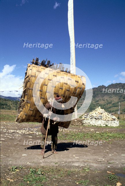 Man carrying a huge load, Bumthang, Bhutan.