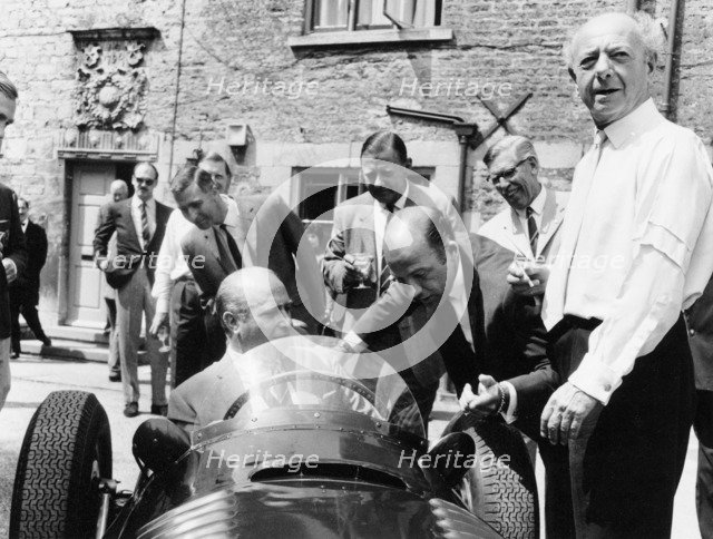 Juan Manuel Fangio at the wheel of a V16 BRM, (1960s?). Artist: Unknown