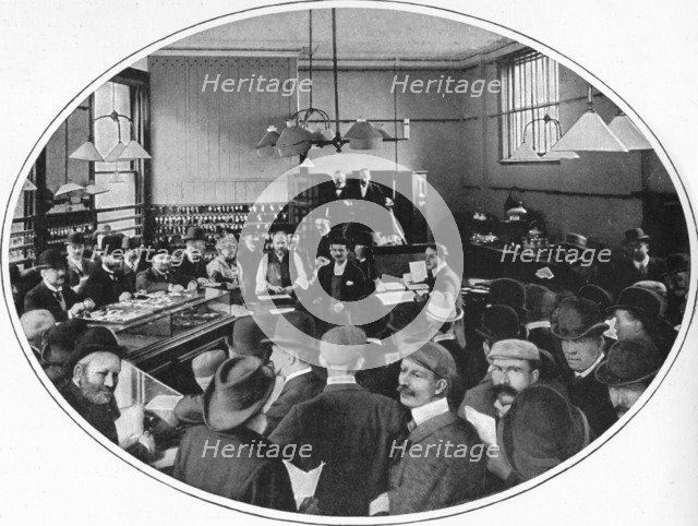 Sale of unredeemed goods at Debenham, Storr and Sons auction rooms, London, c1903 (1903). Artist: Unknown.