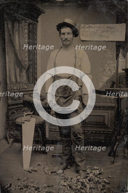 Carpenter or Cabinetmaker Standing Before a Sign Advertising His Trade, 1860s-80s. Creator: Unknown.