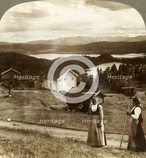'Country girls in haying time - over Bolkesjo and Folsjo (lakes) to Himingen Mts., Norway', c1905.  Creator: Unknown.