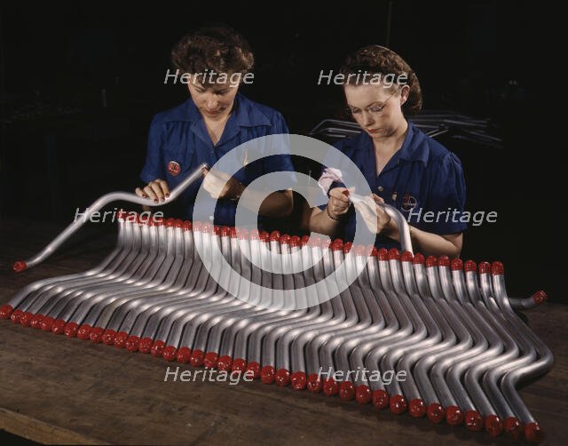 Two women workers are shown capping and inspecting tubing...Vultee's Nashville..., Tennessee, 1943. Creator: Alfred T Palmer.