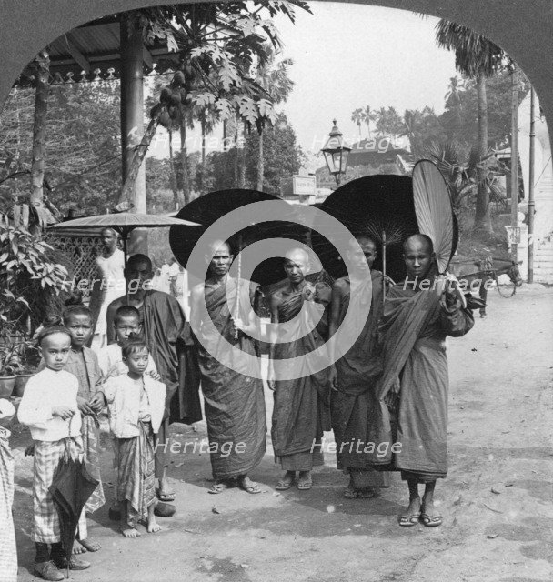 Buddhist monks with sunshades and fans, Rangoon, Burma, 1908. Artist: Stereo Travel Co