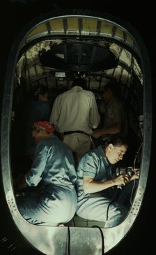 Working inside fuselage of a Liberator Bomber, Consolidated Aircraft Corp., Fort Worth, Texas, 1942. Creator: Howard Hollem.