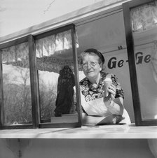 The first ice cream of the year; woman in her ice cream stall, Landskrona, Sweden, 1953. Artist: Unknown