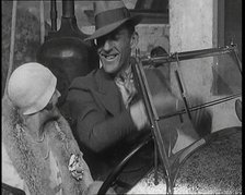 Jack Hulbert Climbing Into a Car And Getting His Fingers Stuck in Windscreen, 1920s. Creator: British Pathe Ltd.