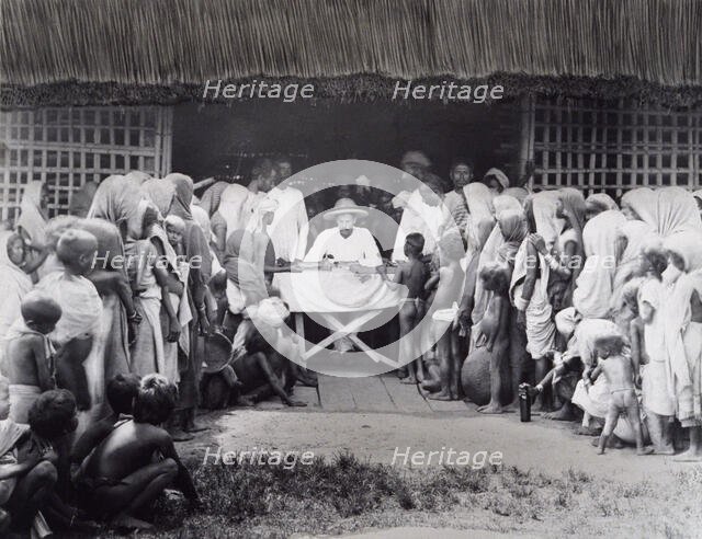 Paying wages to tea estate labourers, Bengal, 1880s. Creator: Bourne & Shepherd.
