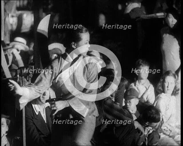 A Female Civilian in a Traditional Robe Dancing With Sabres As People Watch Her Performanc..., 1932. Creator: British Pathe Ltd.