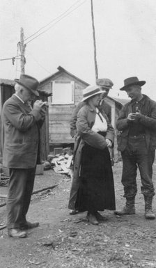 Woman and three men talking outside, between c1900 and 1916. Creator: Unknown.