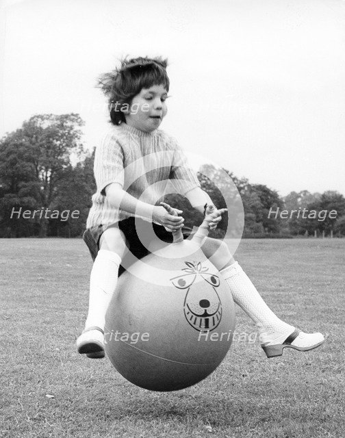 Girl on a space hopper, 1970s.